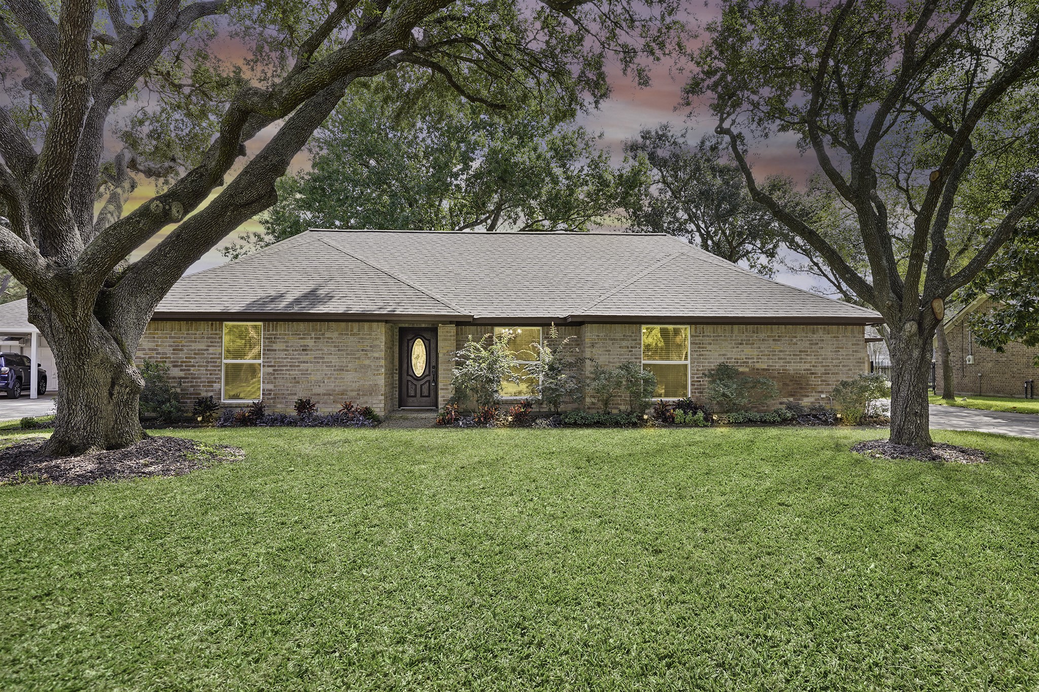 a view of a yard in front of a house with large tree