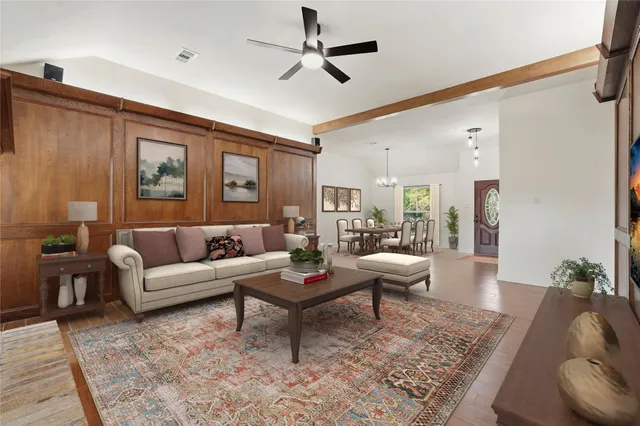 a bedroom with a bed and a flat tv screen on wall