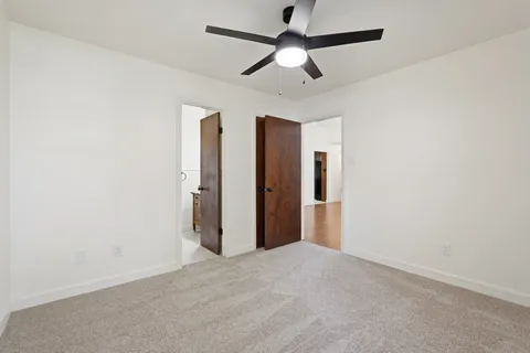 a view of empty room with ceiling fan