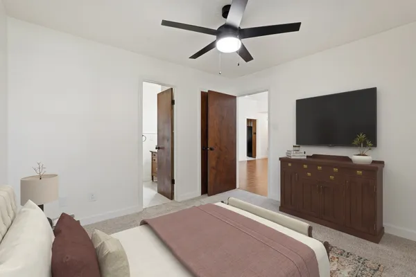 an empty room with fan and windows