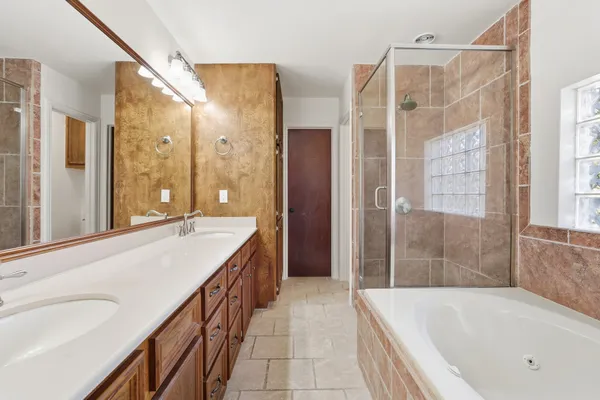 a bathroom with a tub and shower