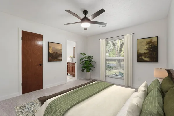 an empty room with window and ceiling fan