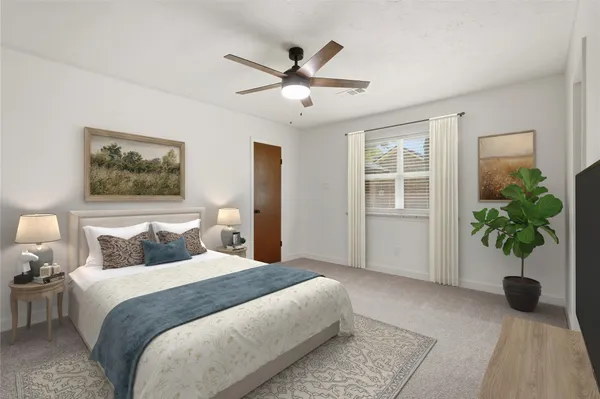 a bedroom with a bed and a potted plant