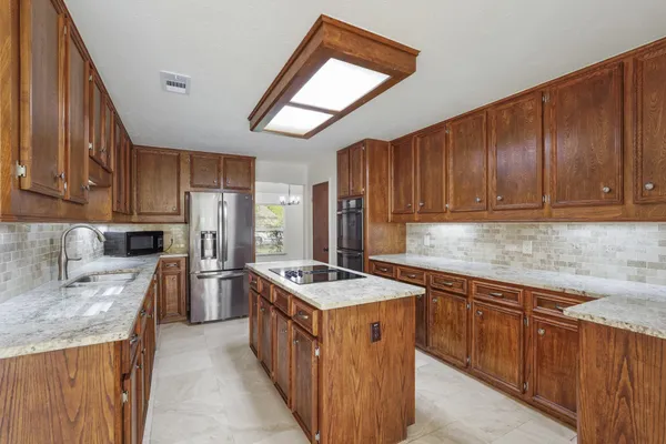 a living room with furniture a dining table and a potted plant