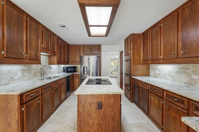 a view of a patio with a table chairs and a backyard