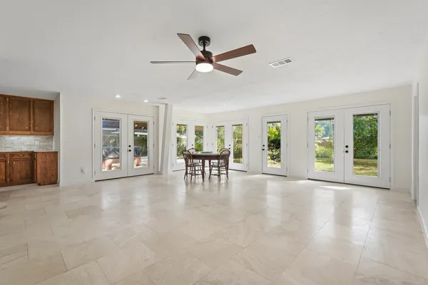 a view of a patio with a table chairs and a backyard