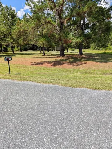 a wooden bench sitting in middle of a field