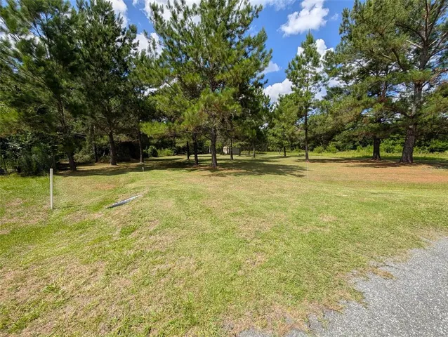 a view of a big yard with a trampoline