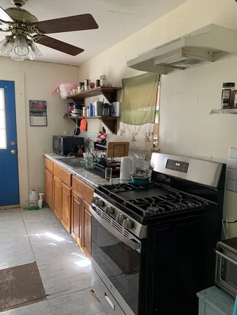 a kitchen with a stove and a refrigerator