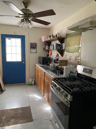 a view of a kitchen with a sink and a refrigerator
