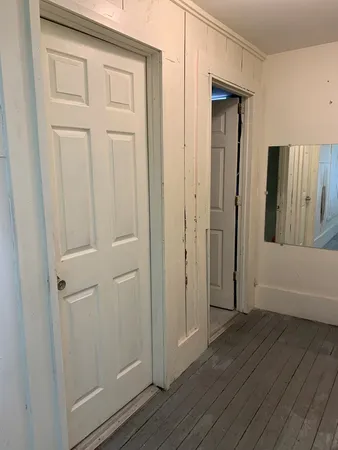 a bedroom with a bed flowerpot and window