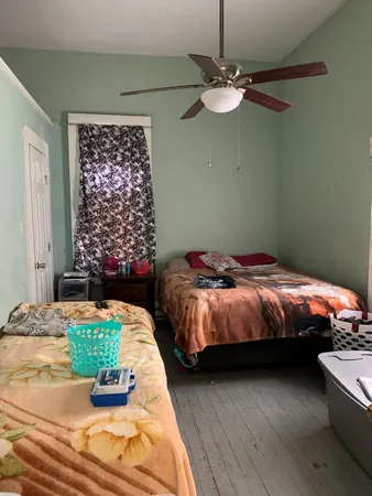 a bed room with a bed and a mirror