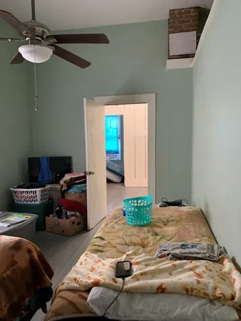 a bedroom with a bed and a window