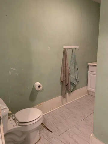 a room with water heater and wooden floor