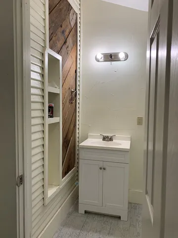 a white toilet sitting next to a bathroom sink