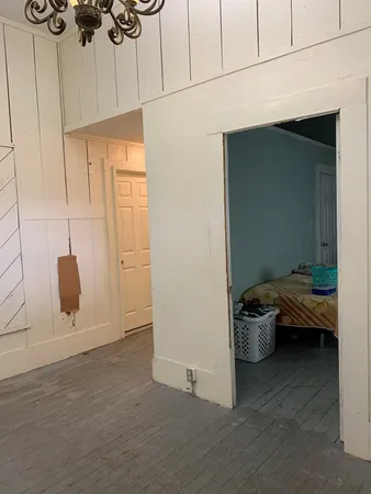 a bedroom with a bed and a chandelier