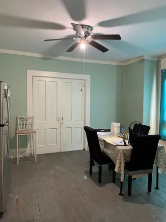 a view of a dining room with furniture and window