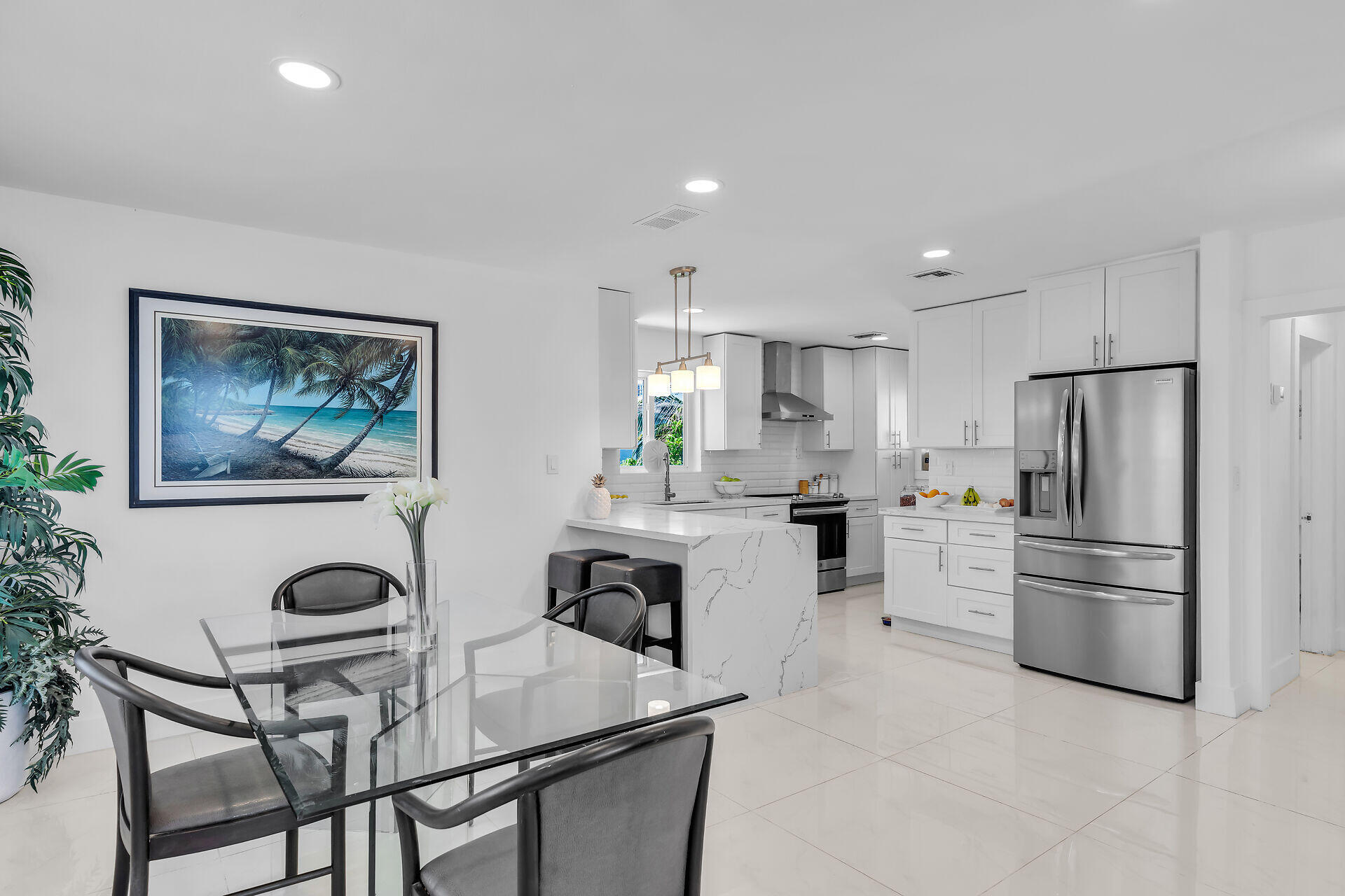 309 Jasmine Street Duck Key, FL 33050 - Photo 16 of 37 a kitchen with stainless steel appliances a refrigerator a stove a dining table and chairs