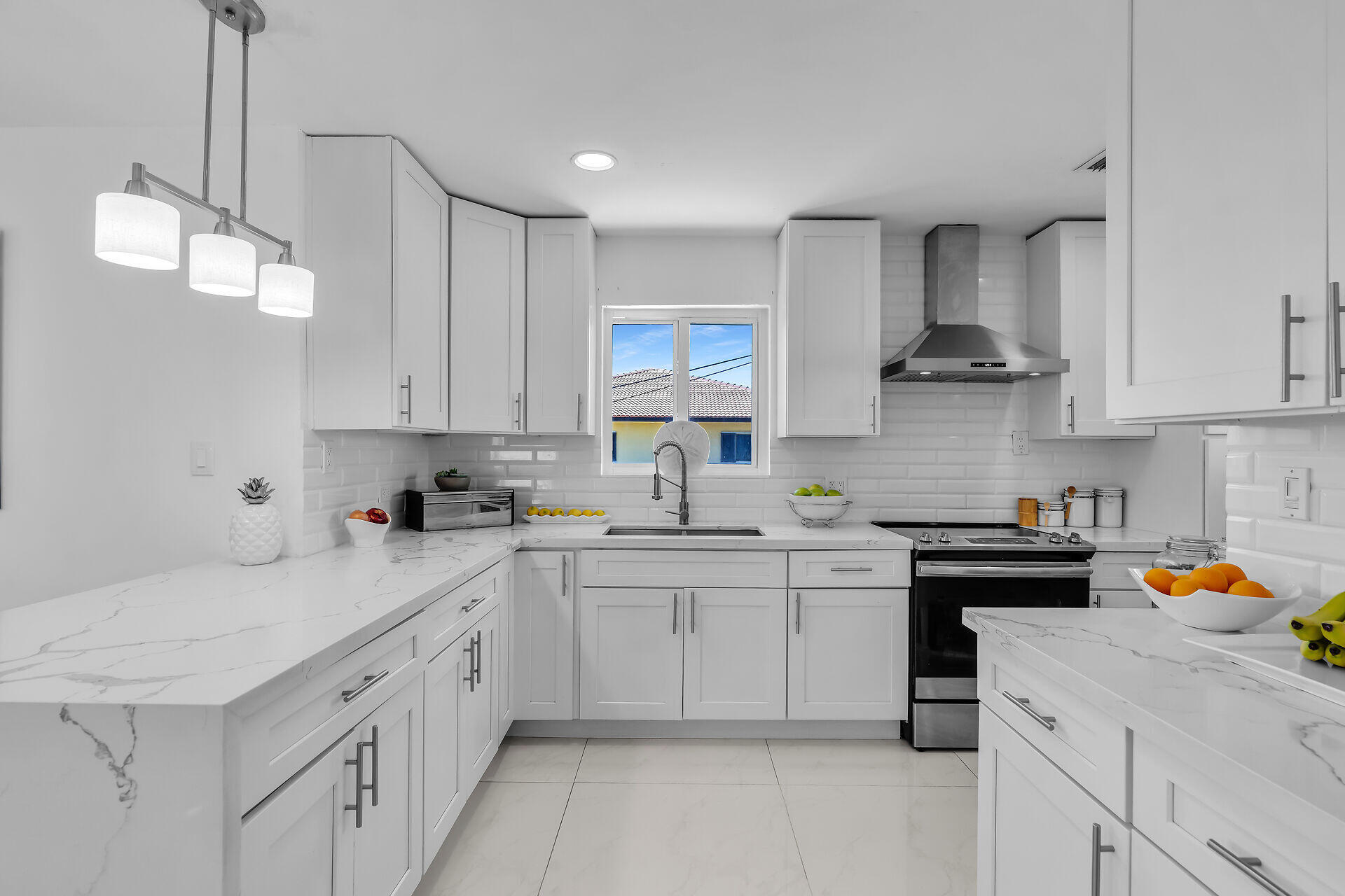 309 Jasmine Street Duck Key, FL 33050 - Photo 19 of 37 a kitchen with a sink dishwasher and white cabinets