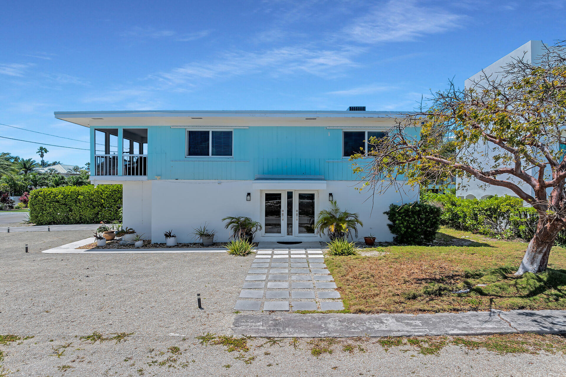 309 Jasmine Street Duck Key, FL 33050 - Photo 2 of 37 front view of house with potted plants