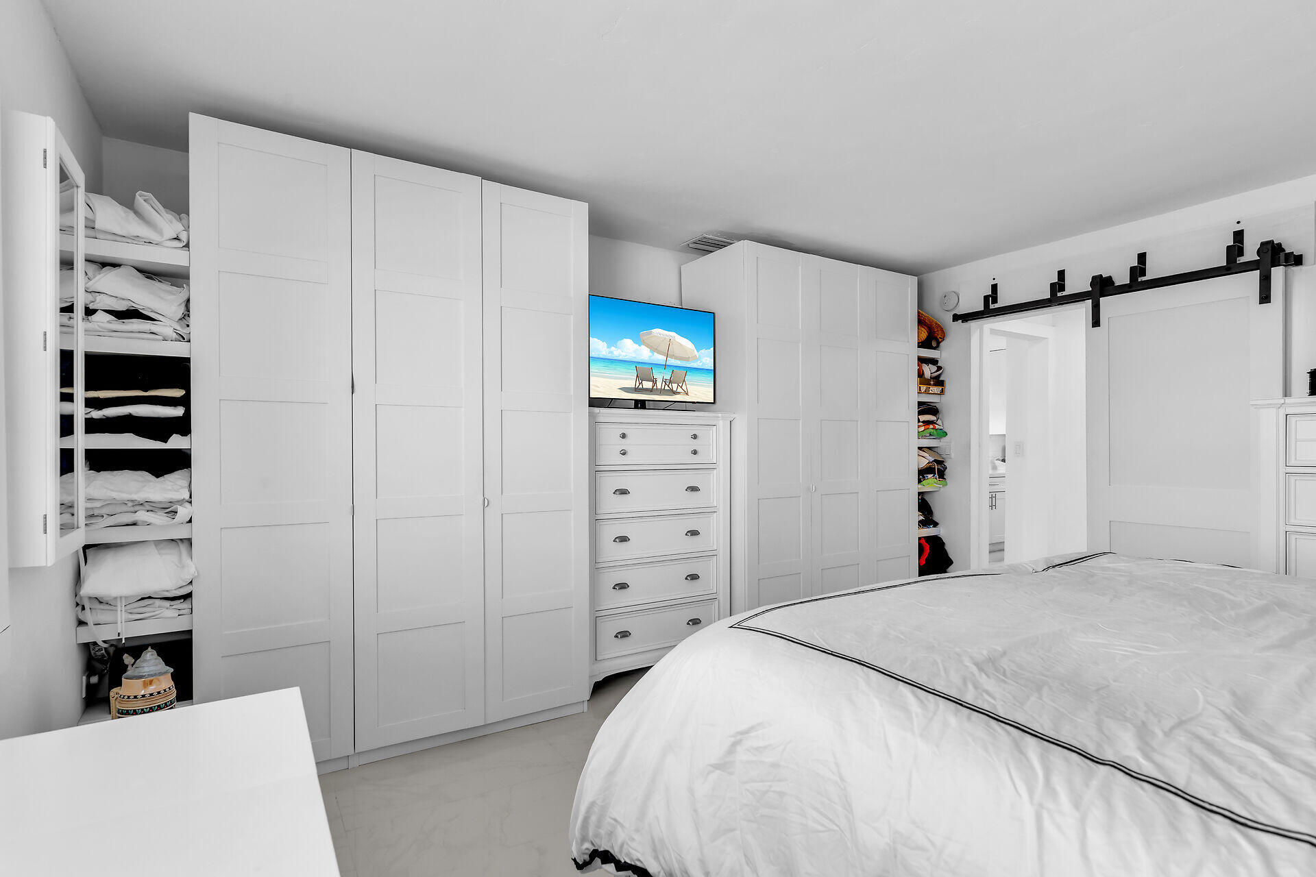 309 Jasmine Street Duck Key, FL 33050 - Photo 25 of 37 a bedroom with a bed and a walk in closet