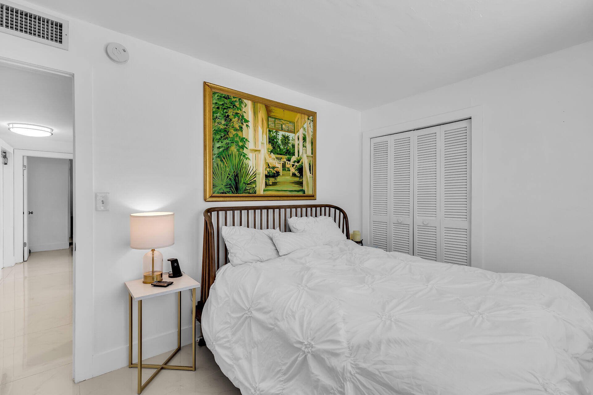 309 Jasmine Street Duck Key, FL 33050 - Photo 30 of 37 a bedroom with a bed and a lamp on table