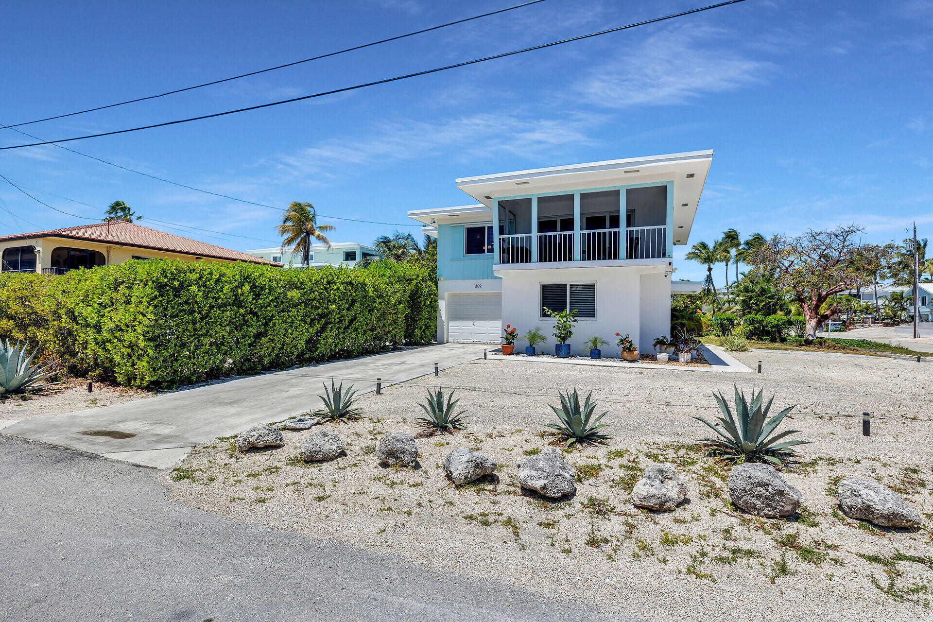 309 Jasmine Street Duck Key, FL 33050 - Photo 3 of 37 a front view of a house with a yard