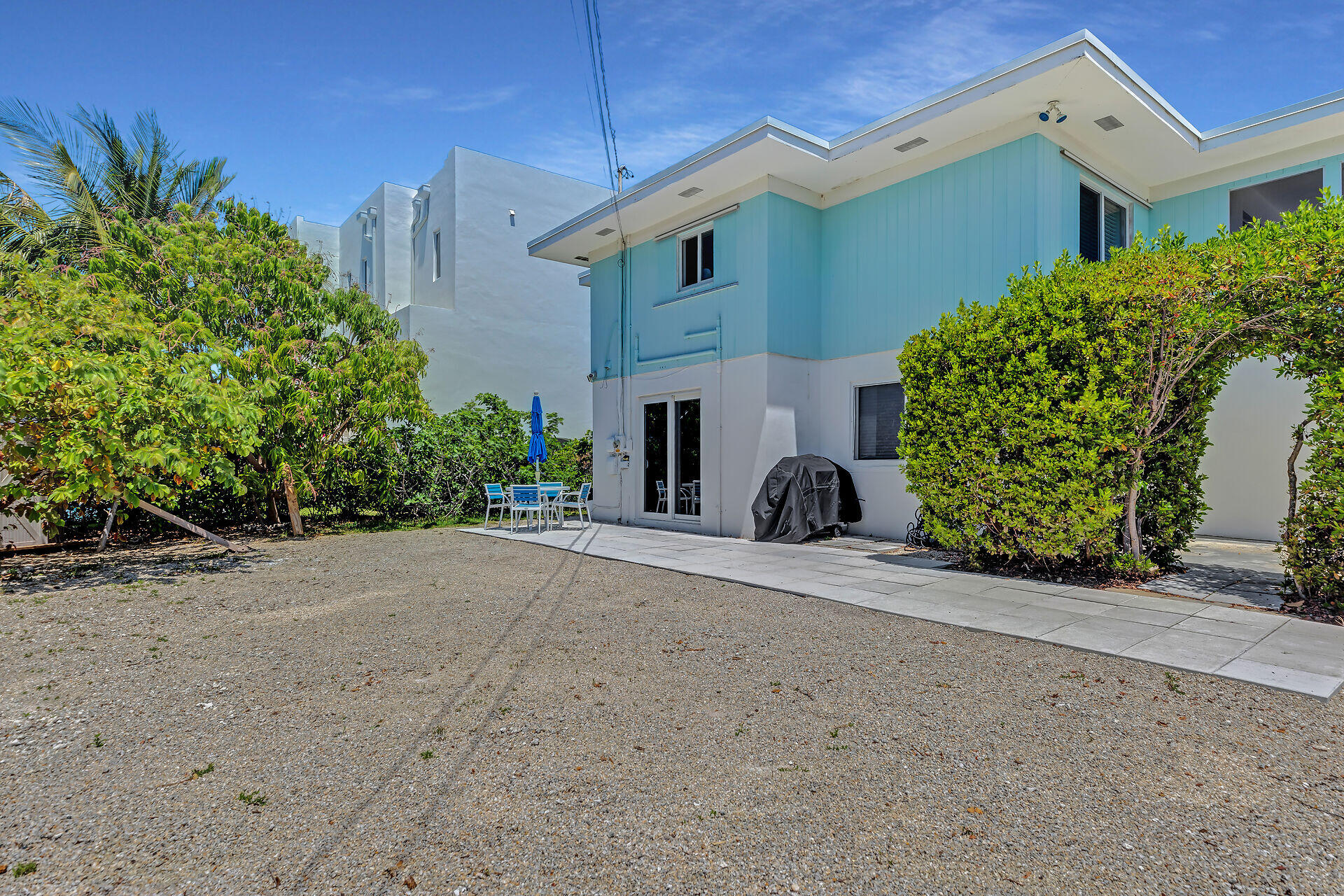 309 Jasmine Street Duck Key, FL 33050 - Photo 4 of 37 a front view of a house with garden