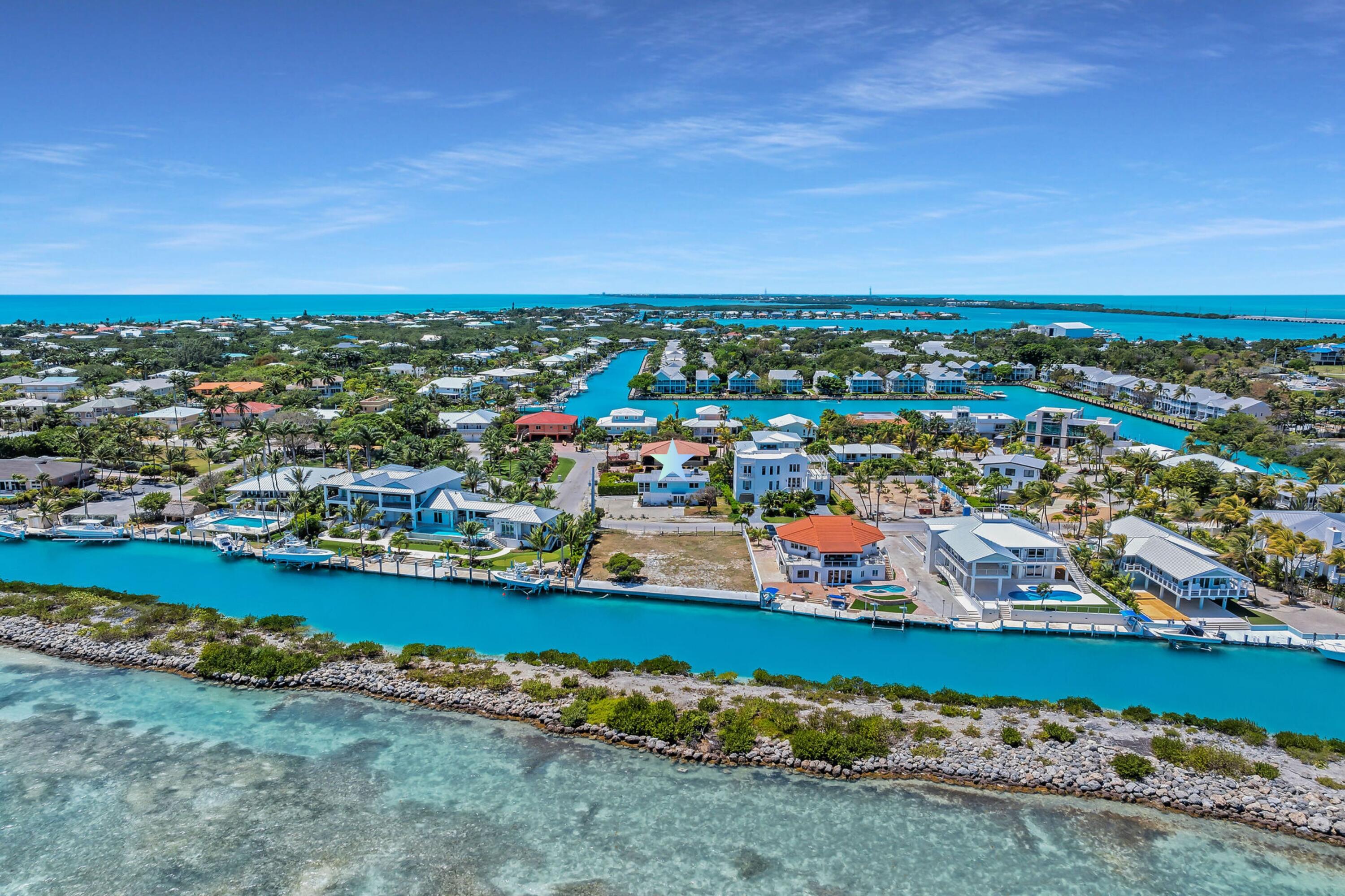 309 Jasmine Street Duck Key, FL 33050 - Photo 7 of 37 an aerial view of a city with lots of residential buildings ocean and mountain view in back