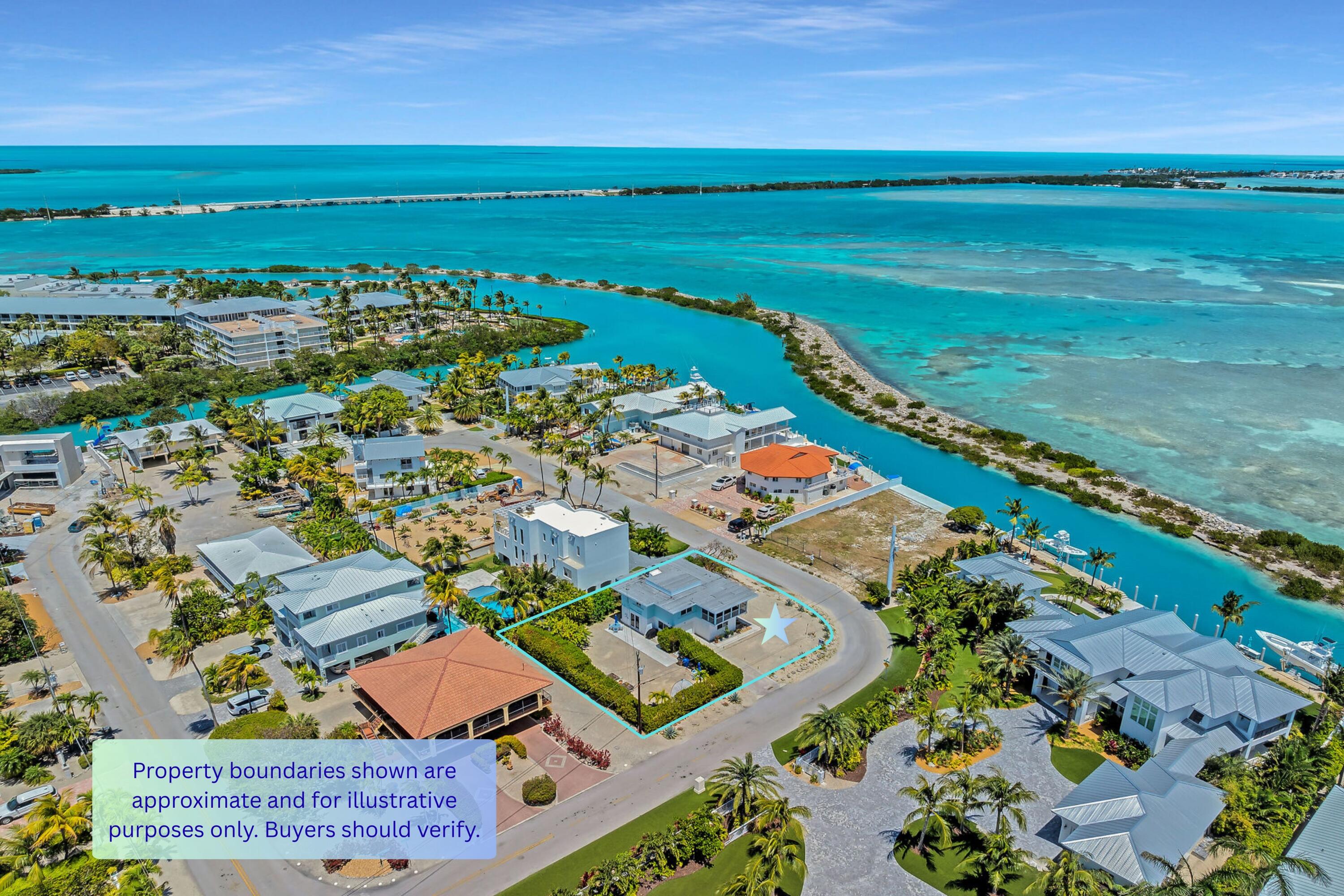 309 Jasmine Street Duck Key, FL 33050 - Photo 10 of 37 an aerial view of a city with lots of residential buildings ocean and mountain view in back