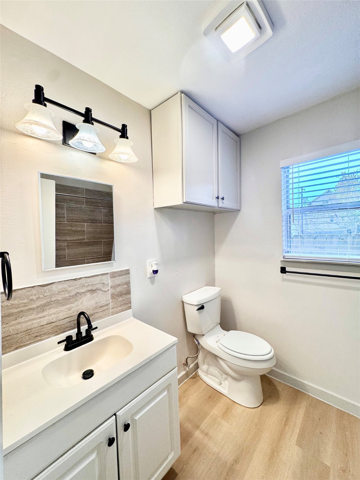 1307 Willard Street, Unit 4 Houston, TX 77006 - Photo 12 of 26 a bathroom with a sink vanity granite toilet and a mirror