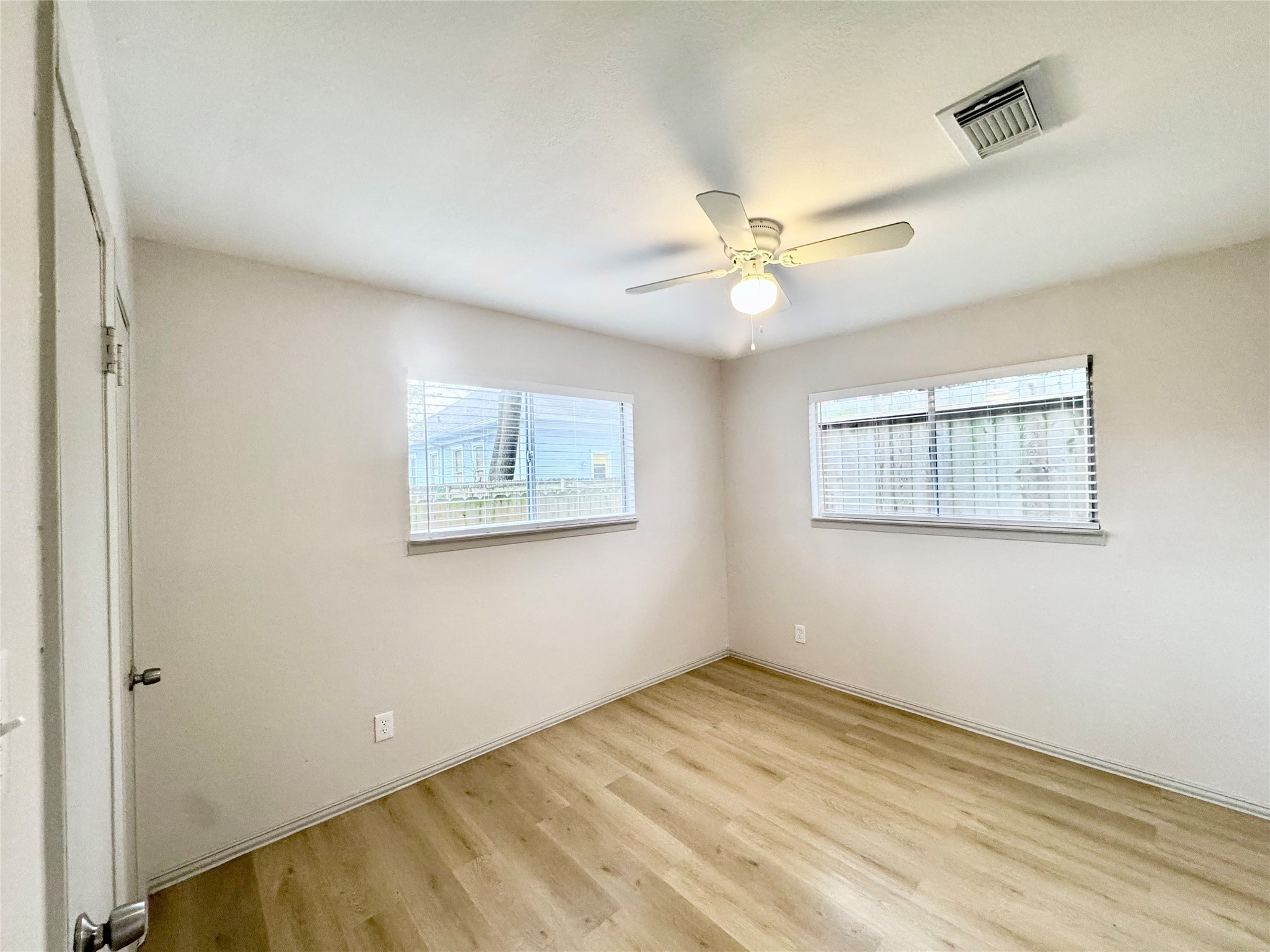 1307 Willard Street, Unit 4 Houston, TX 77006 - Photo 17 of 26 a view of a big room with wooden floor and a ceiling fan