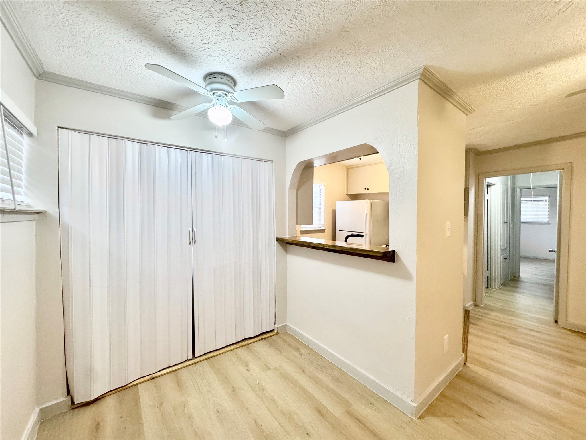 1307 Willard Street, Unit 4 Houston, TX 77006 - Photo 4 of 26 a view of a hallway with a chandelier fan and wooden floor