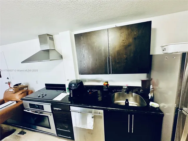 a kitchen with a sink and a refrigerator