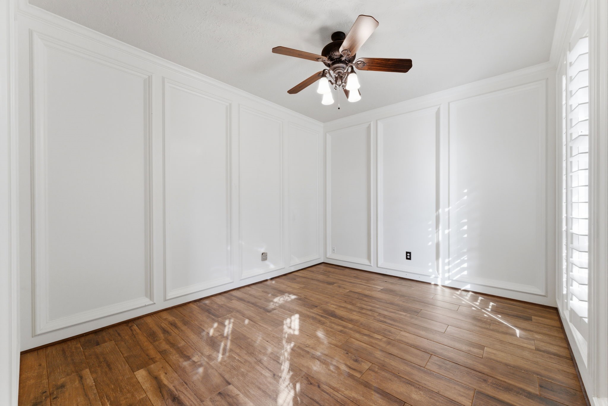 13807 Balmore Circle Houston, TX 77069 - Photo 12 of 30 an empty room with wooden floor chandelier fan and windows