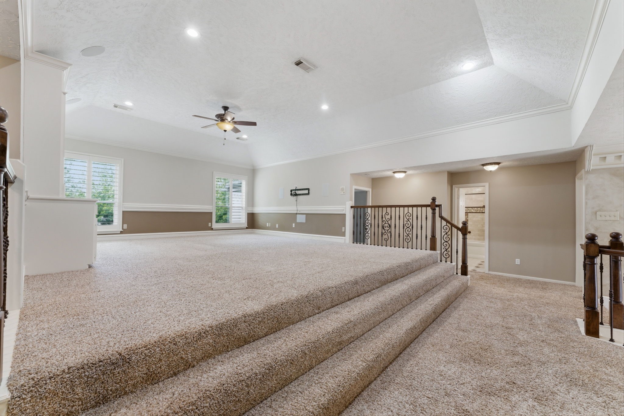 13807 Balmore Circle Houston, TX 77069 - Photo 19 of 30 a spacious bedroom with a large bed and a chandelier
