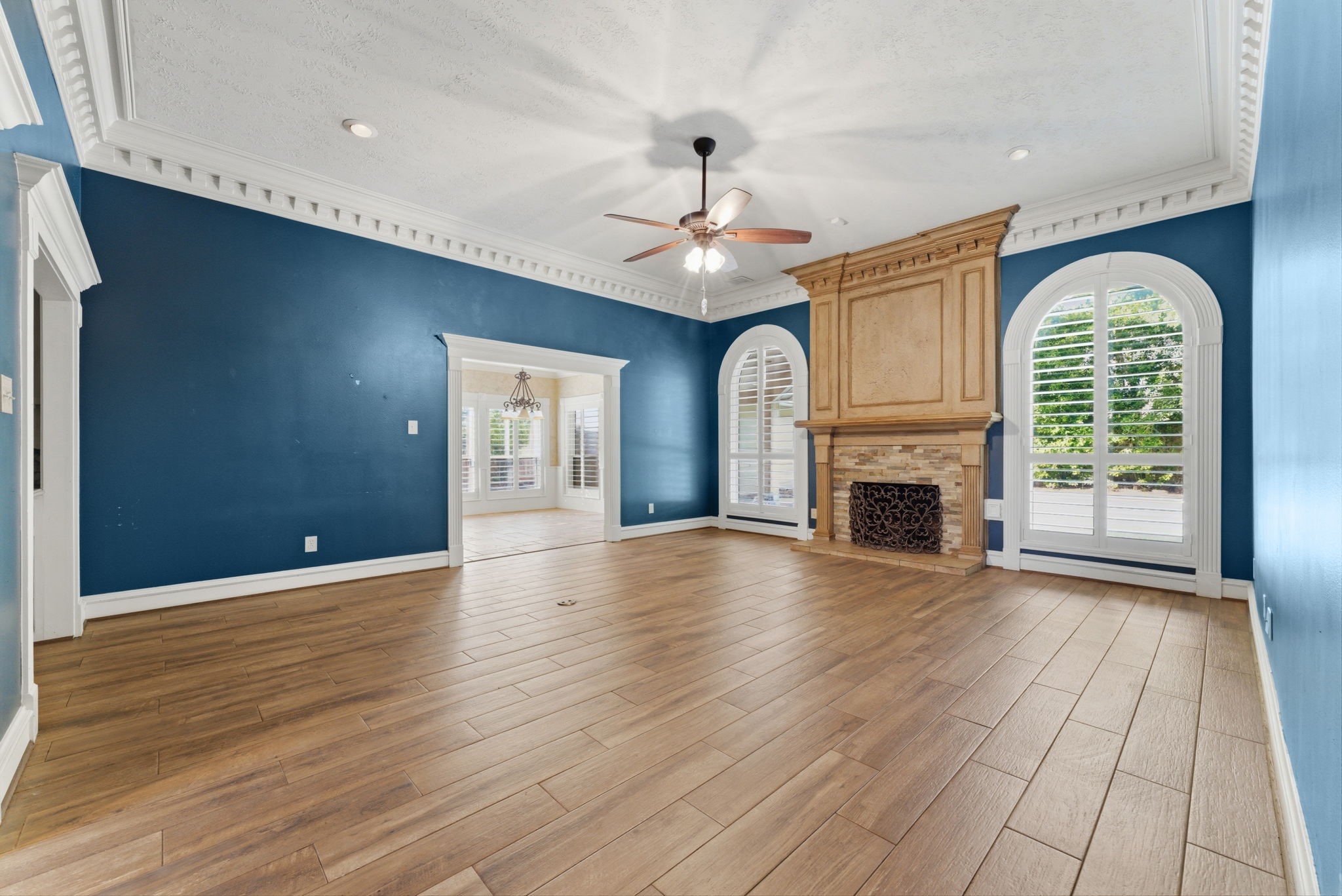 13807 Balmore Circle Houston, TX 77069 - Photo 10 of 30 an empty room with wooden floor fireplace and windows