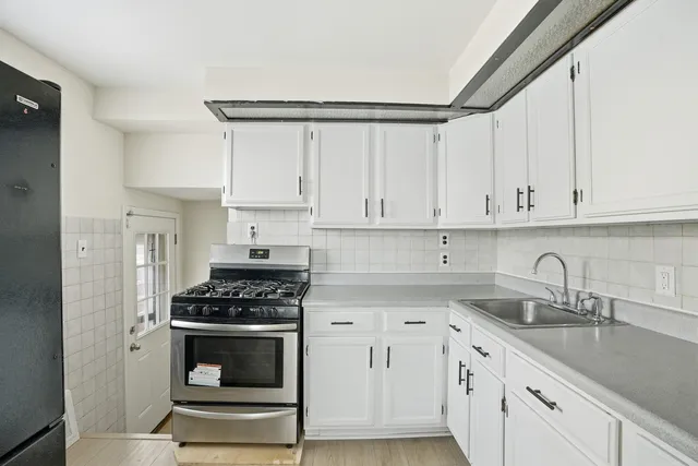 a kitchen with cabinets appliances and a sink