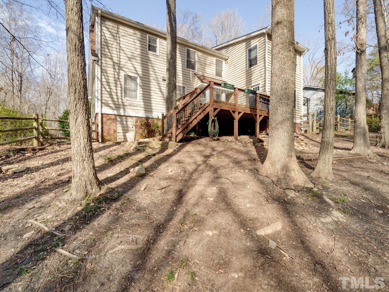 6404 Rushingbrook Drive Raleigh, NC 27612 - Photo 54 of 59 a front view of a house with a yard