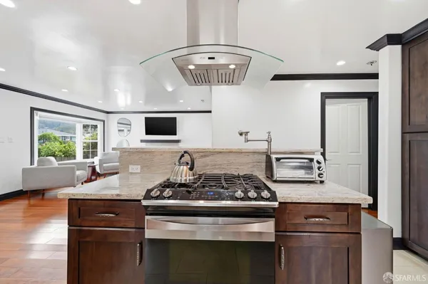 a metallic refrigerator freezer sitting in a kitchen