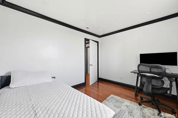 a large bed sitting in a bedroom next to a cabinet