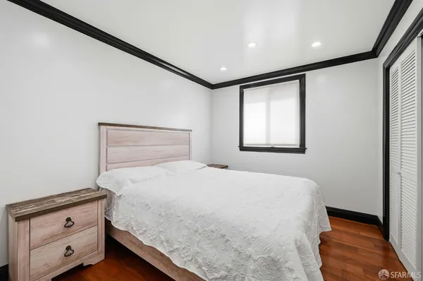 a bedroom with a bed and a ceiling fan