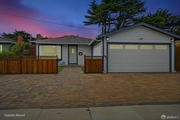 a view of a house with a yard and garage