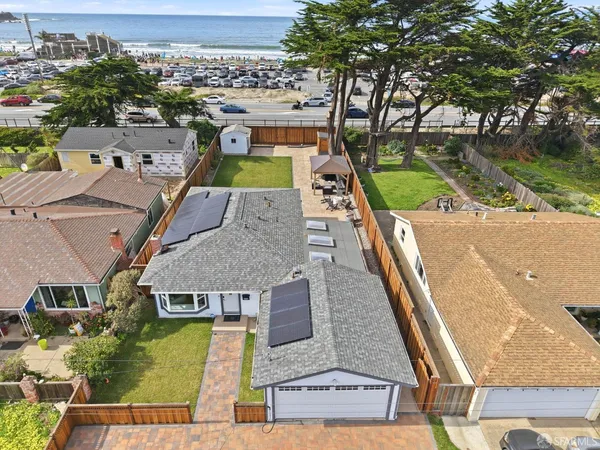 a view of a house with a yard deck and a patio