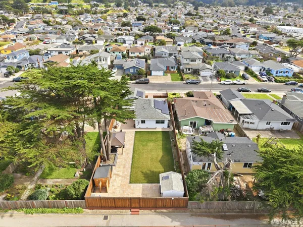 aerial view of a house with a yard
