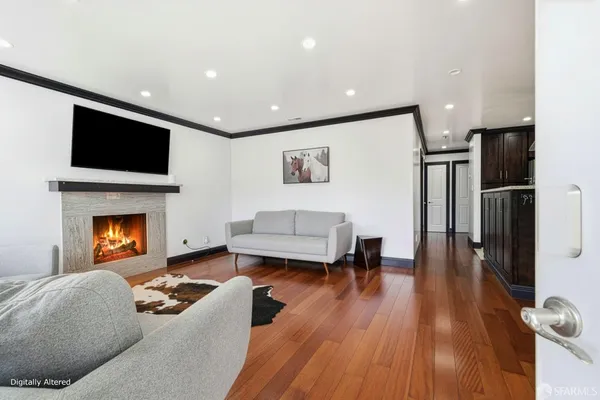 a living room with furniture a flat screen tv and a fireplace