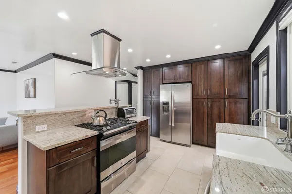 a kitchen with a refrigerator and a sink