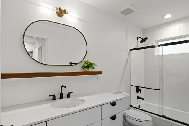 a kitchen with kitchen island a counter space stainless steel appliances and cabinets