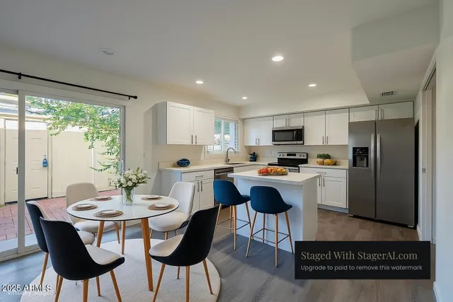 a kitchen with a table chairs refrigerator and cabinets