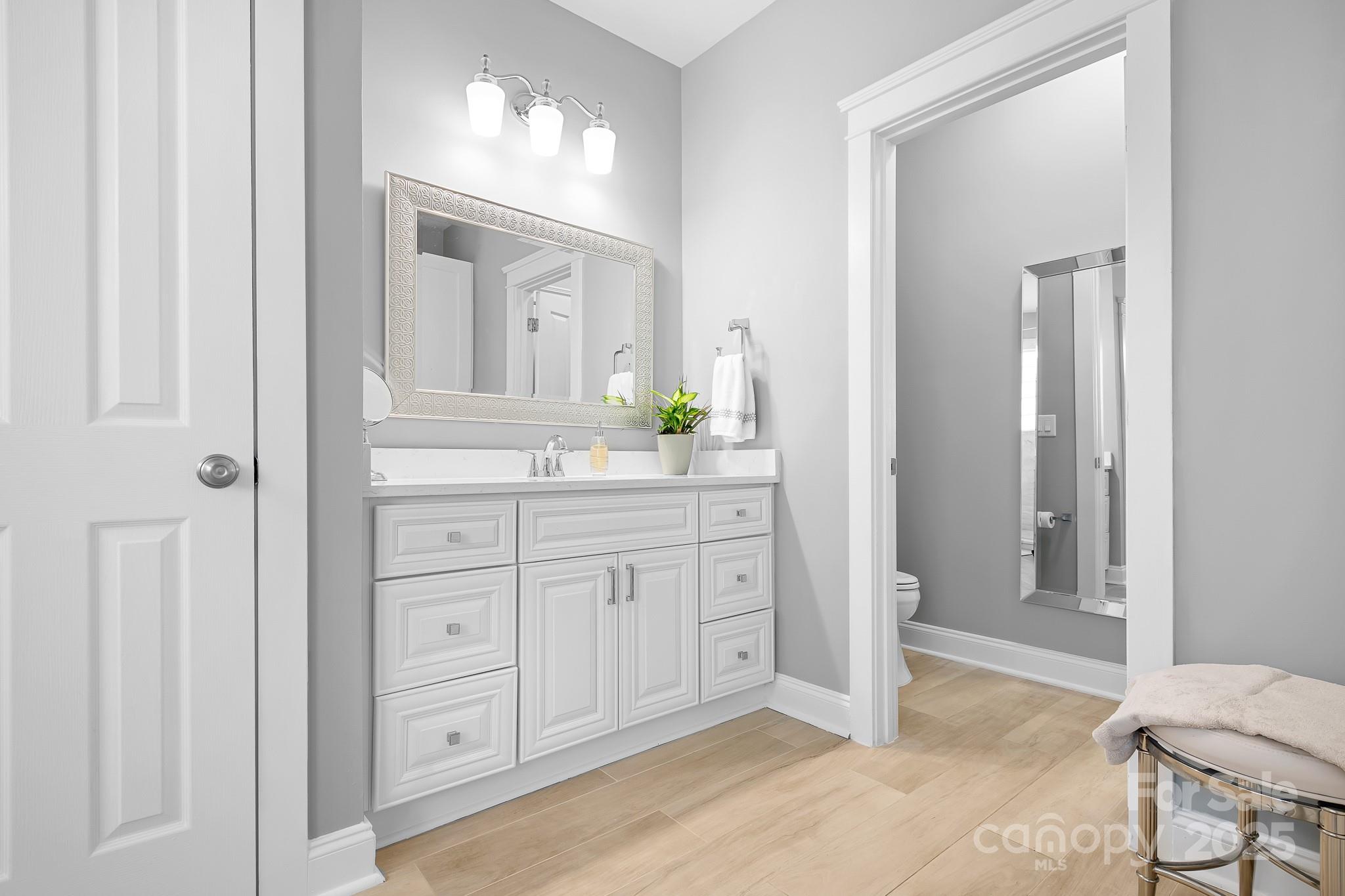 15826 Trenton Place Road Huntersville, NC 28078 - Photo 12 of 32 a spacious bathroom with a granite countertop sink and a mirror